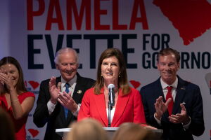 GREENVILLE, SOUTH CAROLINA - JUNE 9: South Carolina Republican gubernatorial candidate Lt. Gov. Pamela Evette, with her husband David, right, and Gov. Henry McMaster, left, speaks to a crowd during an election night watch party on June 9, 2026 at the United Community Bank building in Greenville, South Carolina. Evette advanced to a runoff against state Attorney General Alan Wilson. (Photo by Sean Rayford/Getty Images)